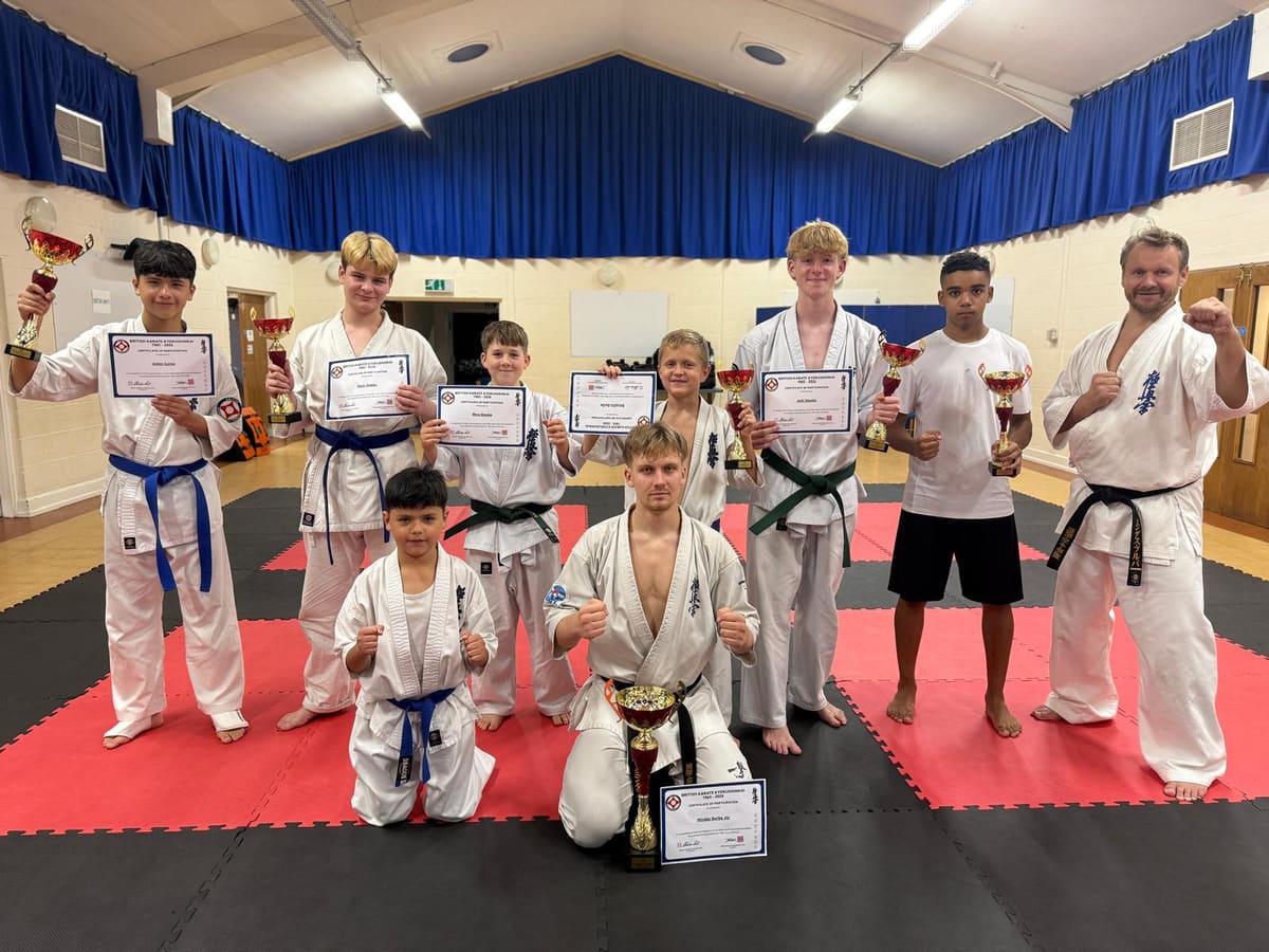 Burton Kyokushin’s supplied squad photograph with trophies and certificates